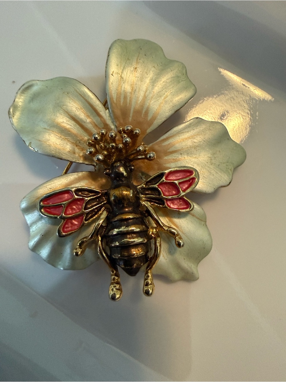 Gold-Tone Bee Brooch with Pink Enamel Wings on White Flower